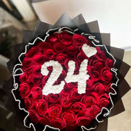 Bouquet of red roses with white "24" decoration and black wrap
