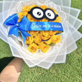 Yellow rose bouquet with a blue ribbon and cartoon glasses decoration
