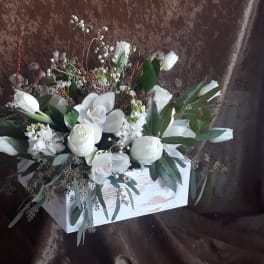 White floral arrangement in a rustic white wooden box
