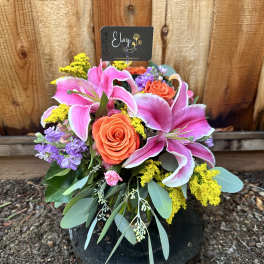 Bouquet of pink lilies and orange roses with purple flowers