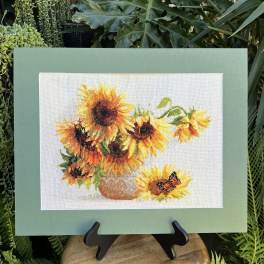 Framed sunflower artwork on an easel