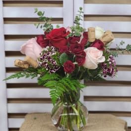 Bouquet of red and pink roses in a clear glass vase