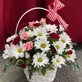 Basket of white daisies and pink roses with a red gingham bow