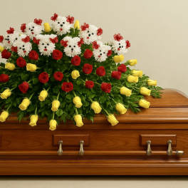 Casket spray of yellow and red roses with white dog-shaped mums on a wooden coffin