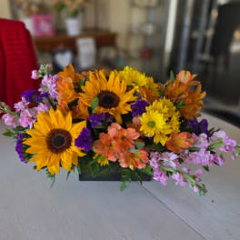 Mixed bouquet with sunflowers, orange alstroemeria, and purple filler flowers