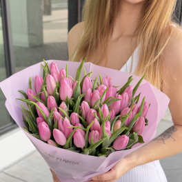 Bouquet of pink tulips wrapped in light pink paper