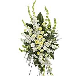 Tall white and pale yellow standing floral spray on a metal easel