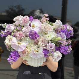 Lavender and pink bouquet in a white vase