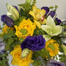 Bouquet of yellow roses, purple lisianthus, and white lilies
