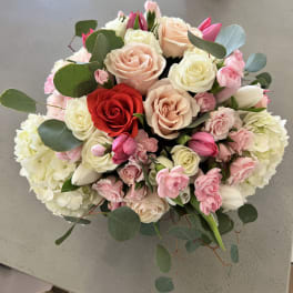 Bouquet of roses, tulips, and hydrangeas in pink, white, and red