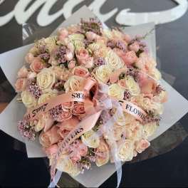 Large bouquet of pale pink and cream roses with ribbon