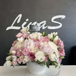 Pink and white floral arrangement in a white vase