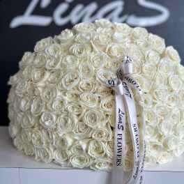 Large dome bouquet of white roses with a printed ribbon bow