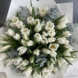 Bouquet of white tulips with eucalyptus in white wrap