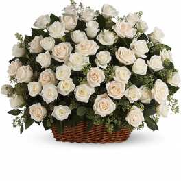 White roses arranged in a wicker basket