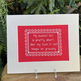 Greeting card with a red stitched message panel on a cream background