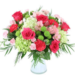 Bouquet of pink and red roses with green pom-pom flowers in a white vase