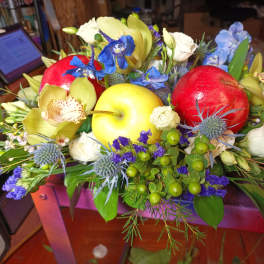 Mixed floral arrangement with apples and blue flowers