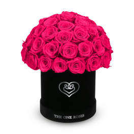 Hot pink roses arranged in a black round box