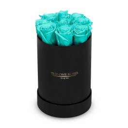 Turquoise roses arranged in a black round box