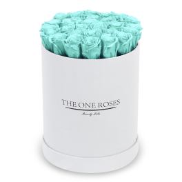 Turquoise roses arranged in a white round box