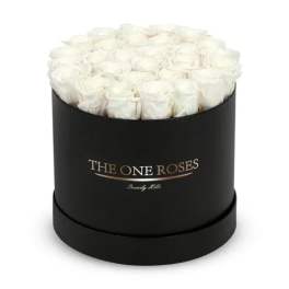 White roses arranged in a black round box