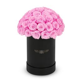 Pink roses arranged in a black cylindrical box