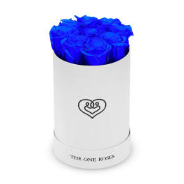 Blue roses arranged in a white cylindrical box