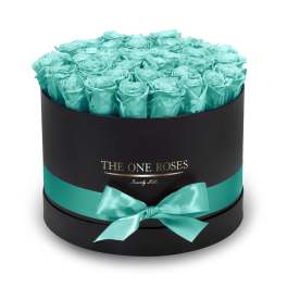 Round black box filled with turquoise roses and a satin bow