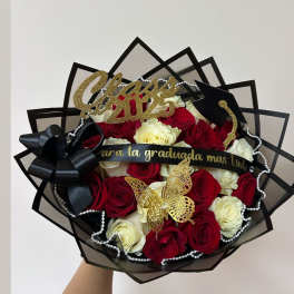 Bouquet of red and white roses with graduation decorations