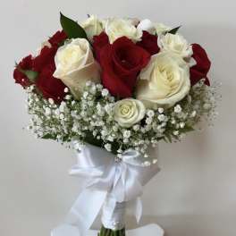 Red and white rose bouquet with baby's breath and a white ribbon