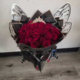 Bouquet of deep red roses wrapped in black paper with butterfly wings