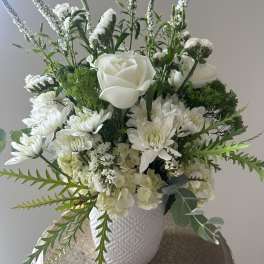 White floral arrangement in a textured white vase