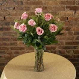 Pink roses arranged in a clear glass vase