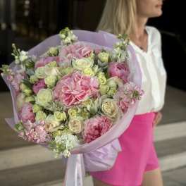 Large pink and cream bouquet wrapped in lavender paper