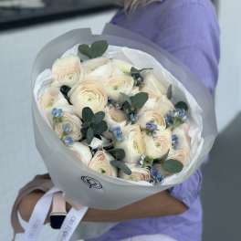 Bouquet of pale ranunculus with blue accents and eucalyptus