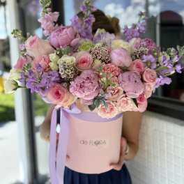 Large pastel bouquet in a pink hat box with lavender ribbon