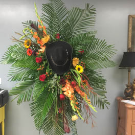 Large floral display with a black cowboy hat in the center