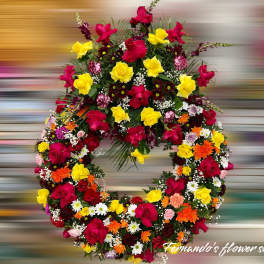 Circular wreath of red and yellow roses with mixed orange and white flowers in a dense design