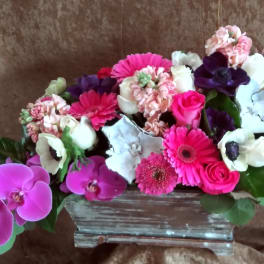 Pink and white mixed flower arrangement in a rectangular vase