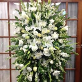 Large white floral standing spray on an easel