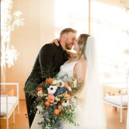 Bride and groom holding a cascading wedding bouquet