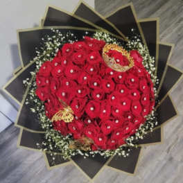 Bouquet of red roses with white filler and black-gold wrapping