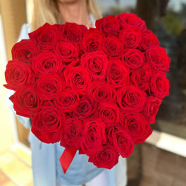 Large bouquet of red roses held by a person