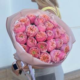 Large bouquet of pink roses wrapped in blush paper