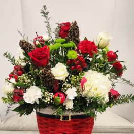 Holiday floral arrangement in a red basket shaped like Santa pants