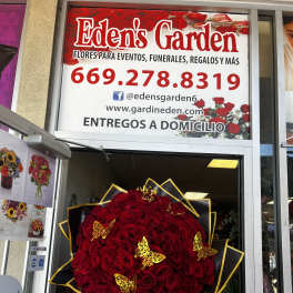 Large red rose bouquet with black and gold wrapping and butterfly accents