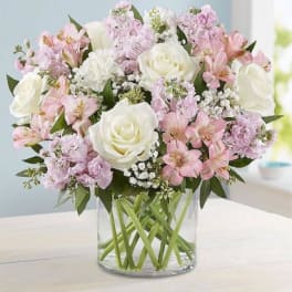 Pink and white bouquet in a clear glass vase