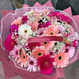 Pink and white gerbera daisy bouquet with a anniversary ribbon