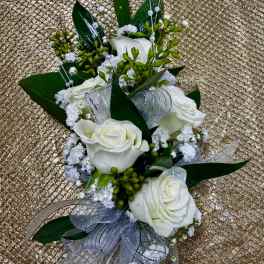 White rose corsage with silver ribbon and pearl accents
